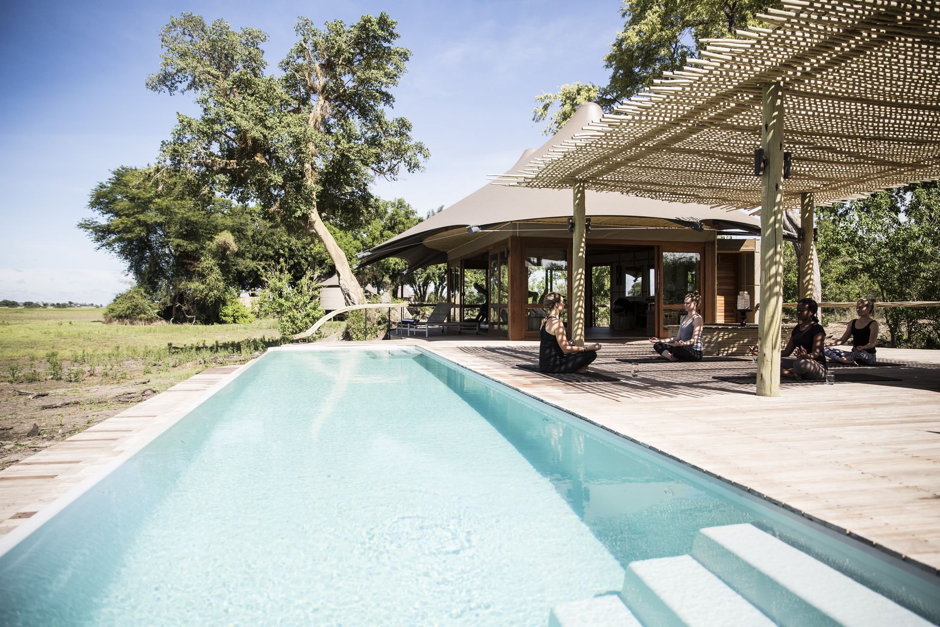 Yoga with at the gym and spa in front of the lap pool